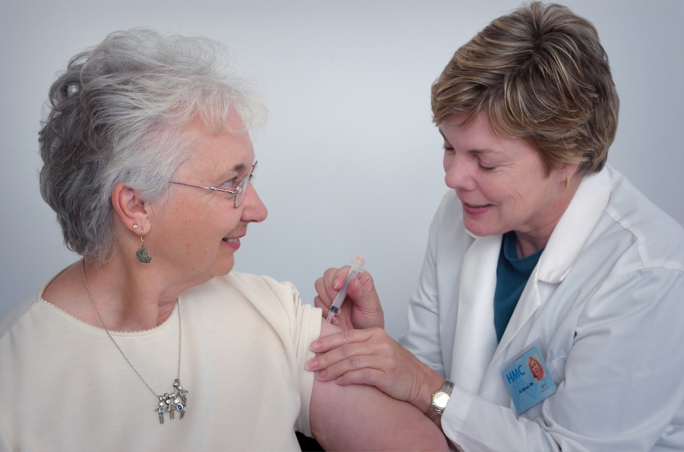 A nurse supporting an older lady at home