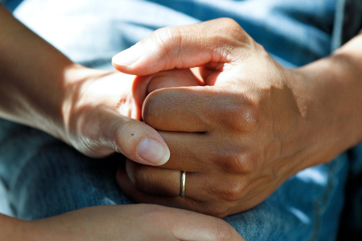A carer holding a client's hands